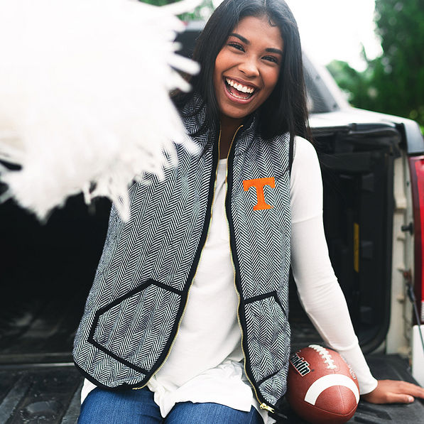 tennessee fan wearing herringbone vest and holding pom pom