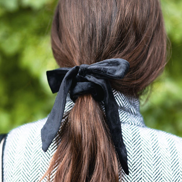 black velvet bow hair tie in brown hair