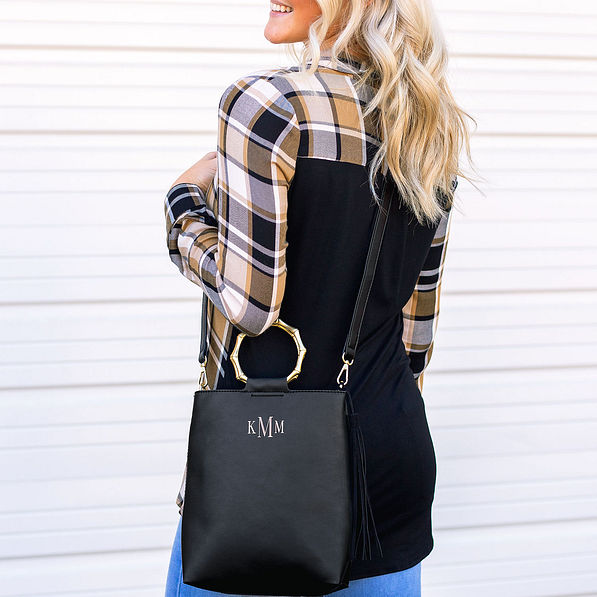 back of black ring handle tote purse with plaid shirt