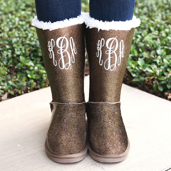 bronze monogrammed sherpa tie booties outside