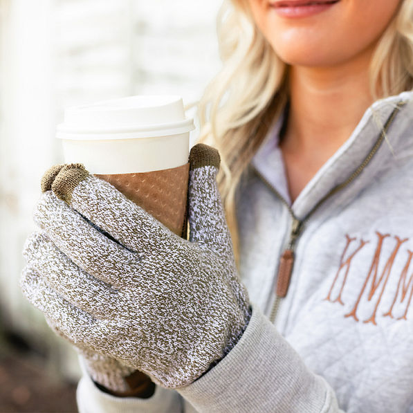 girl holding coffee wearing marbleized knit gloves in brown