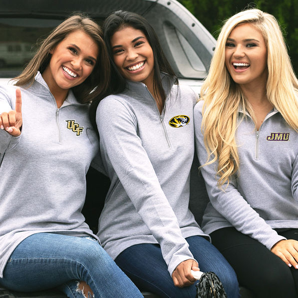 girls in collegiate sweatshirts tailgating