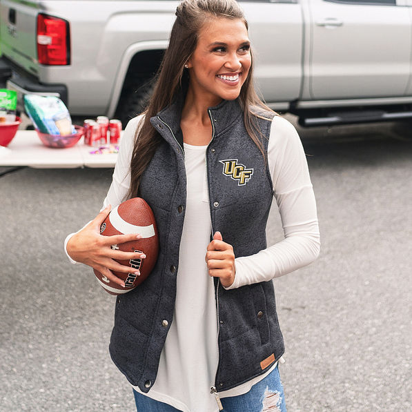 ucf heathered quilted vest in black with white top on brunette holding football