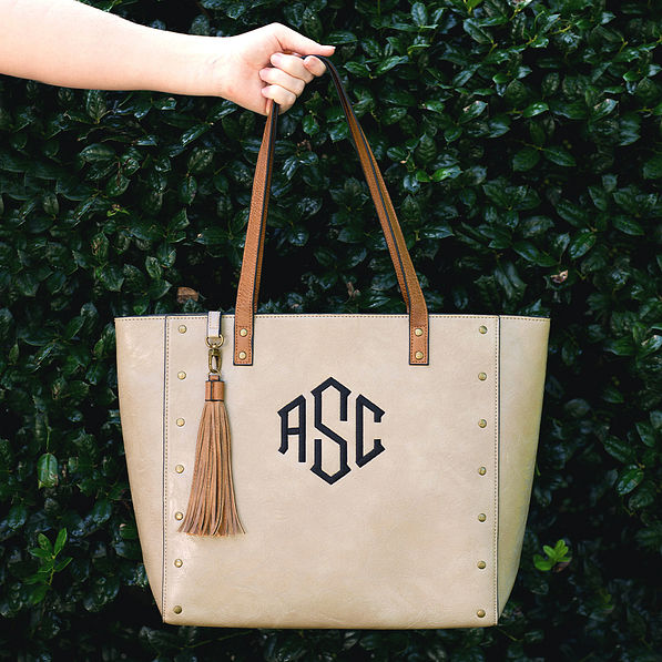 woman holding monogrammed taupe cheyenne tote