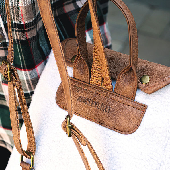 leather detailing on sherpa mini backpack