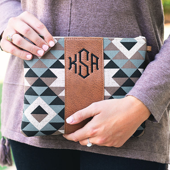 girl holding monogrammed aztec print clutch in hands