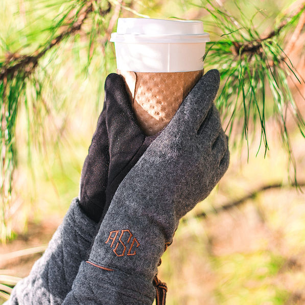 monogrammed gloves on hands holding coffee