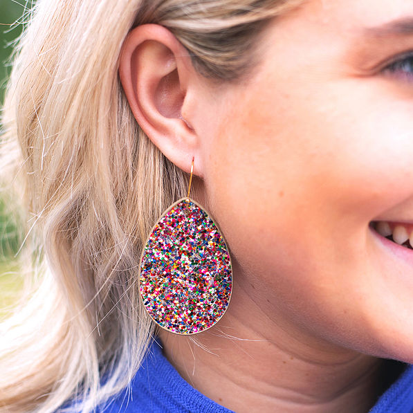 confetti leaf earrings in ear
