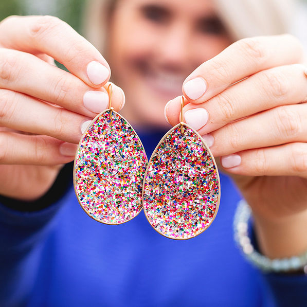 holding confetti leaf earrings