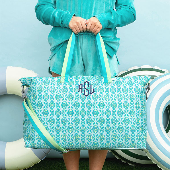arbua mosaic weekend bag in hand with navy monogram