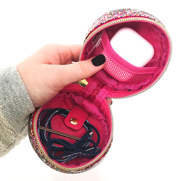 confetti small travel case with hair ties and airpods inside