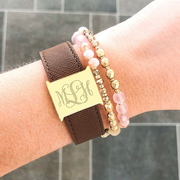 gold monogrammed reversible cuff bracelet on arm