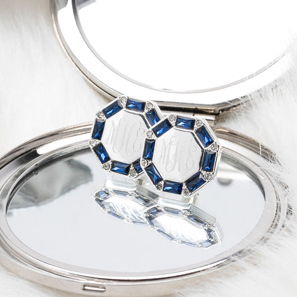 blue monogrammed cushion cut studs on compact mirror