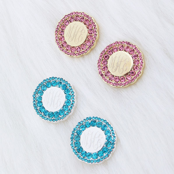 monogrammed rhinestone cluster stud earrings in pink and blue on fur rug