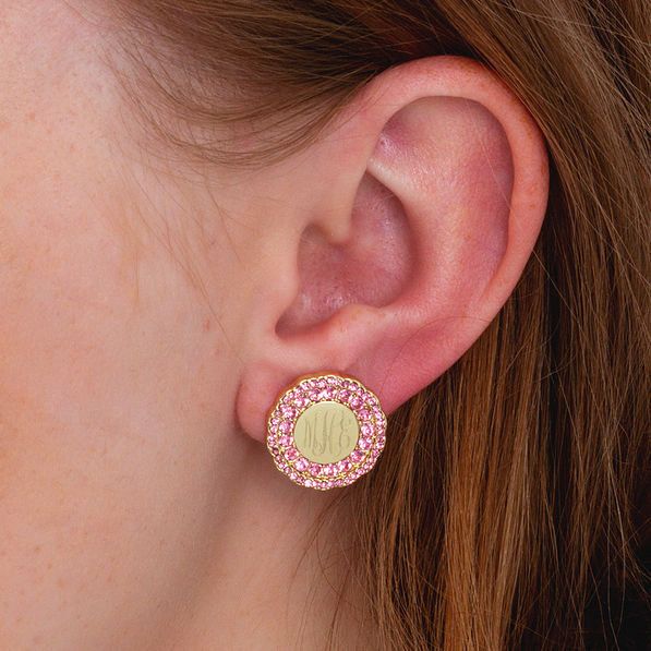 pink and gold monogrammed cluster studs in ear