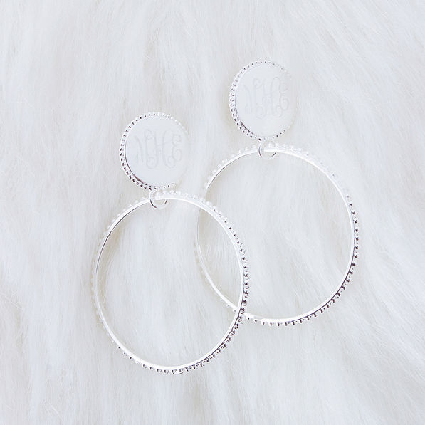 silver monogrammed beaded hoop earrings on faux fur