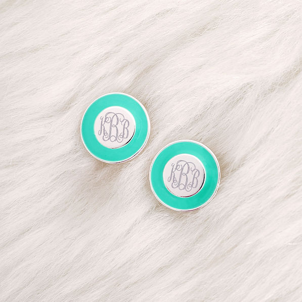 monogrammed mint and silver stud earrings on fur rug