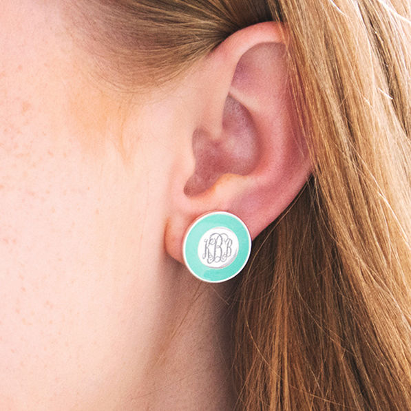 mint enamel monogrammed studs in ears