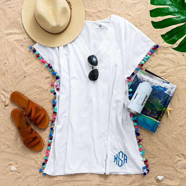 monogrammed pom pom cover up in white styled for vacation