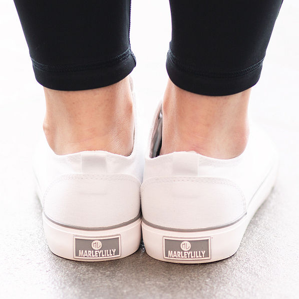 marleylilly branding on the back of monogrammed white canvas sneakers