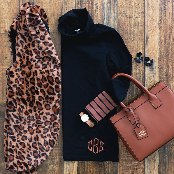 monogrammed black layering turtleneck with leopard vest and monogrammed handbag