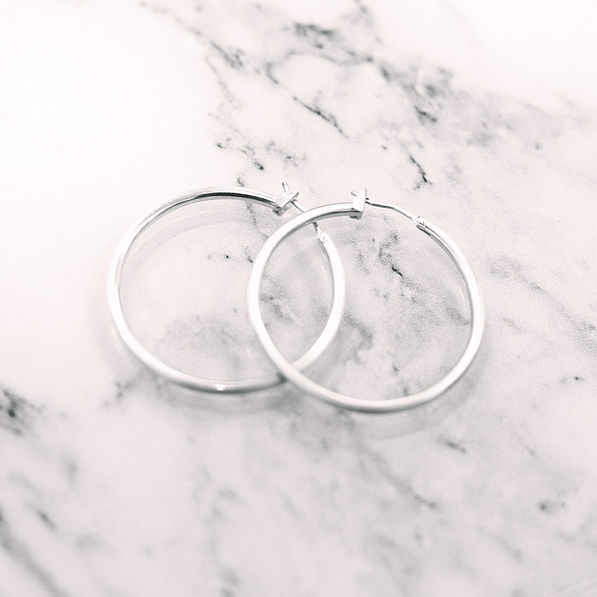 silver featherweight hoops on marble