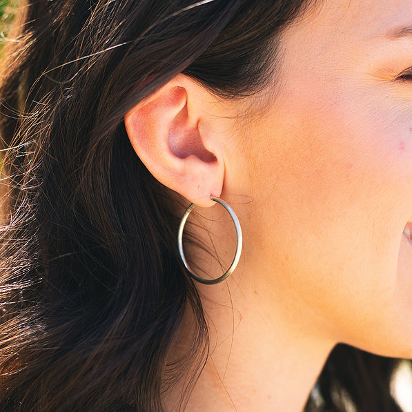 silver hoops in ear