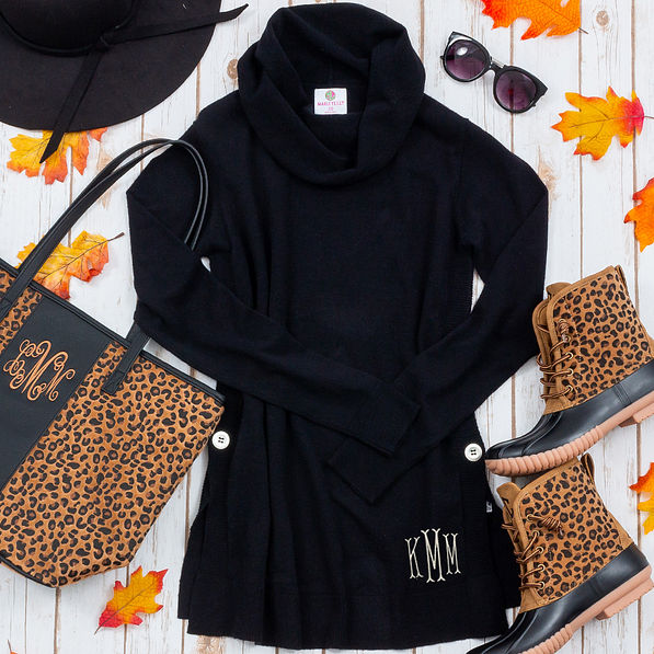 black cowl neck flat lay with leopard accessories