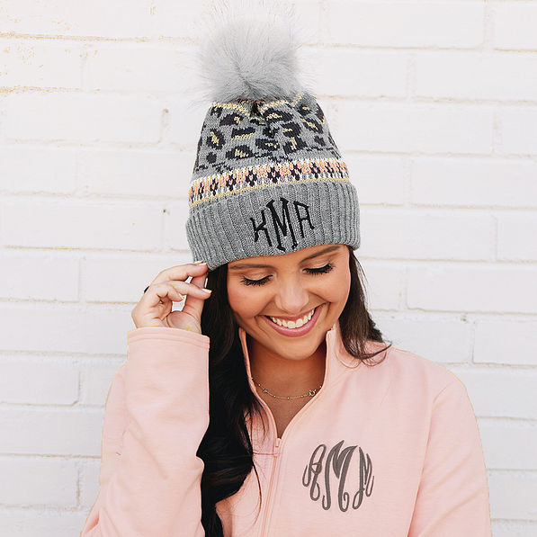 girl wearing gray leopard pom pom beanie with heather pink pullover