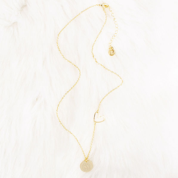 gold heart necklace on faux fur