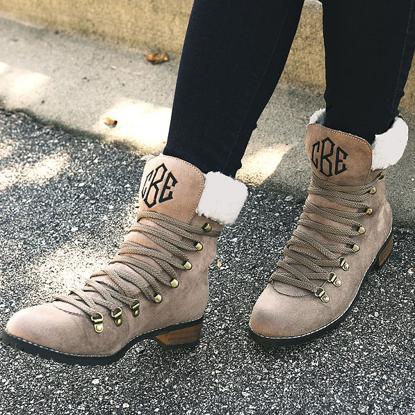 monogrammed sueded lace up boots on pavement