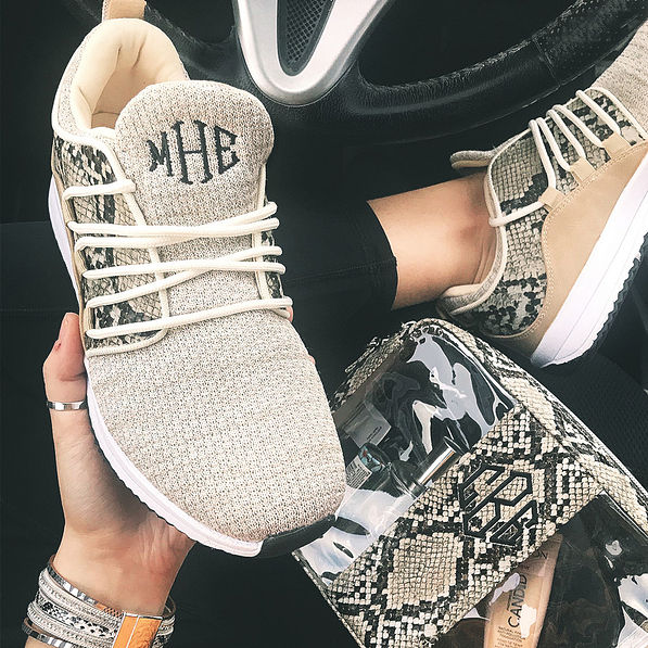 monogrammed snakeskin athletic sneakers in car with purse