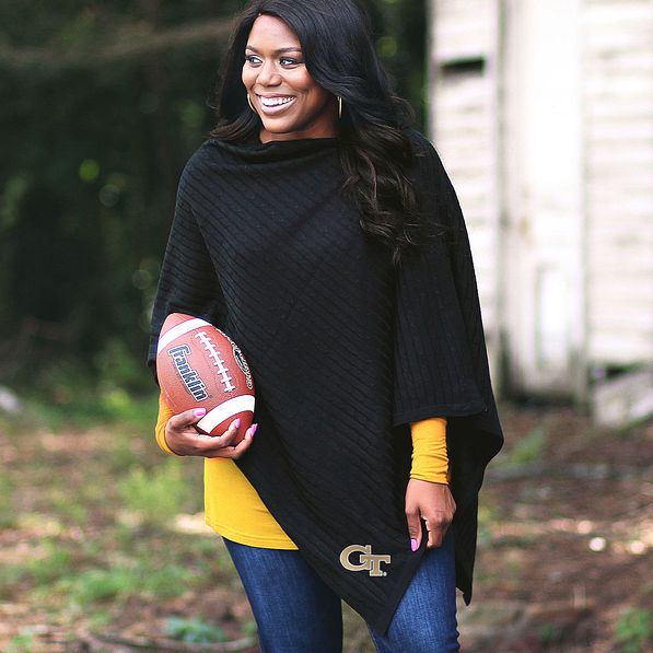 black ga tech poncho on girl holding football