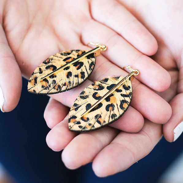 leopard faux fur earrings in hand