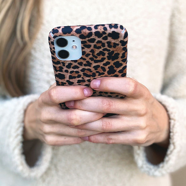 girl texting on phone with leopard case