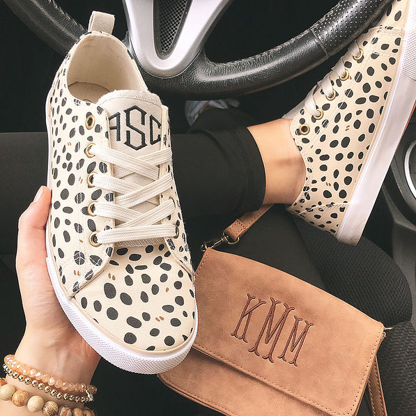 monogrammed spotted sneakers in car with crossbody