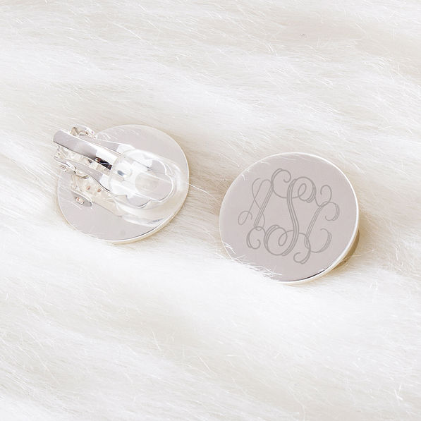 monogrammed clip on earrings on fuzzy rug