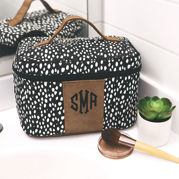 train case with black and white print on bathroom counter