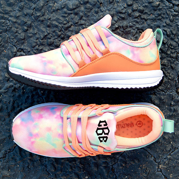 monogrammed tie dye sneakers on black asphalt