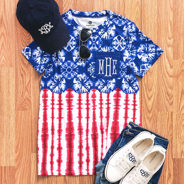 red, white, and blue monogrammed tie dye t-shirt flatlay