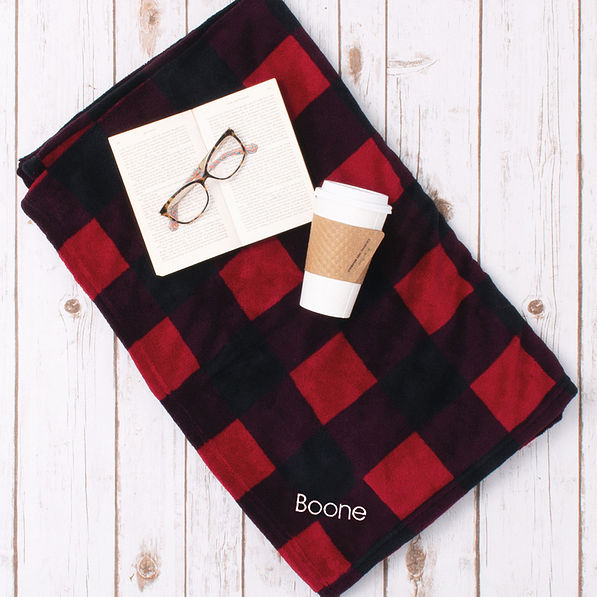 flatlay of buffalo plaid blanket with name
