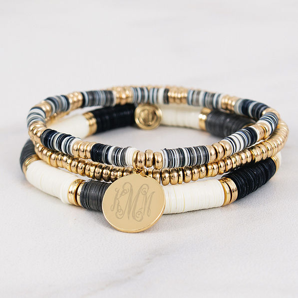 monogrammed stackable beaded bracelets on marble counter