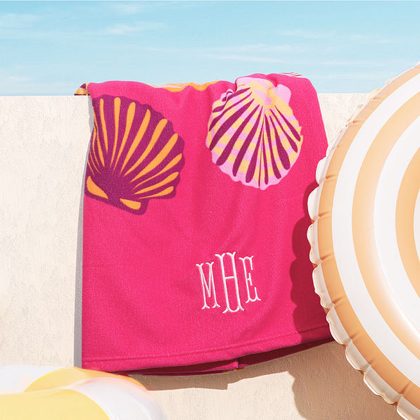 close up of personalized beach towel in fuchsia shells