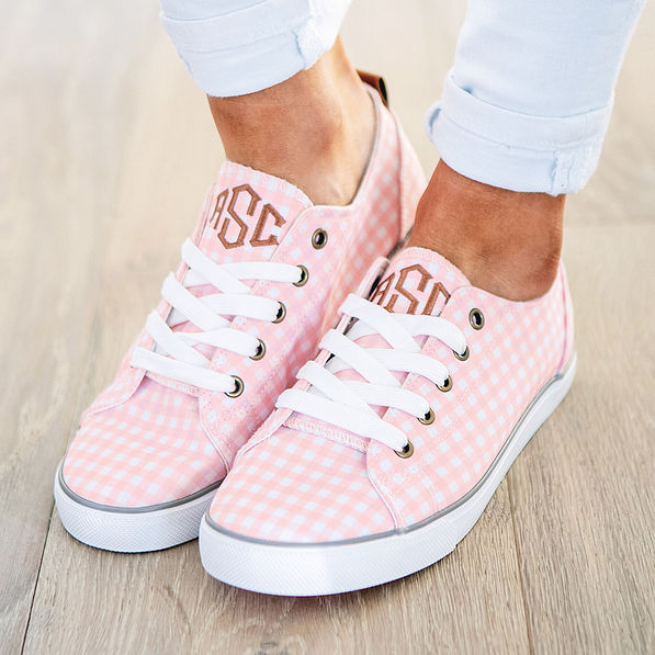pink monogrammed gingham sneakers with white pants