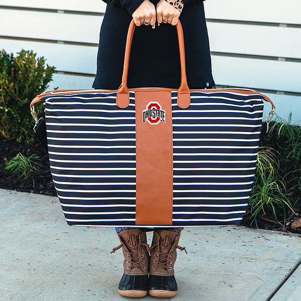 girl holding ohio state weekender bag
