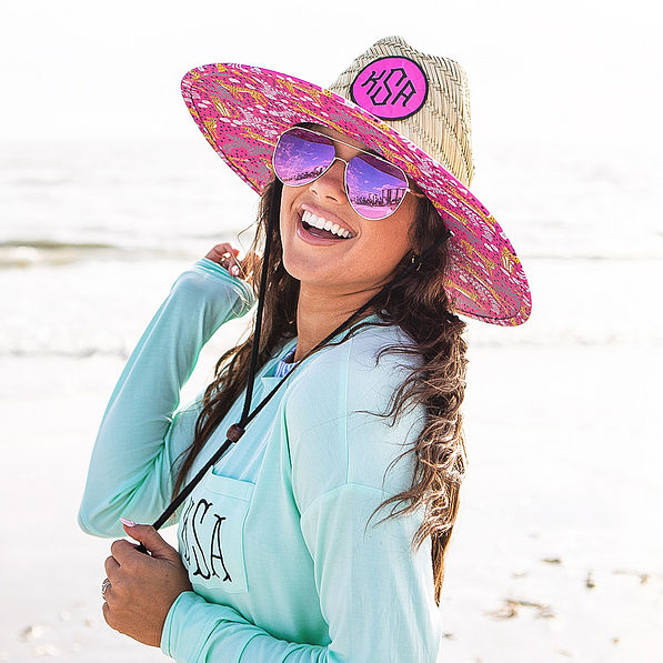 pink fiesta straw hat on beach
