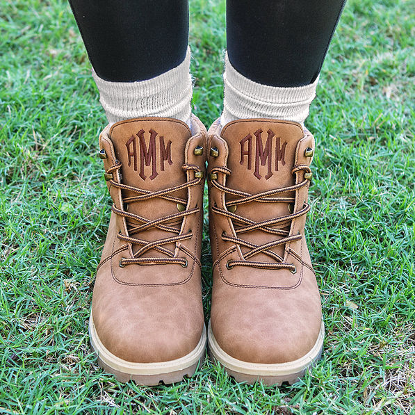 brown monogrammed hiking boots with leggings and tan socks