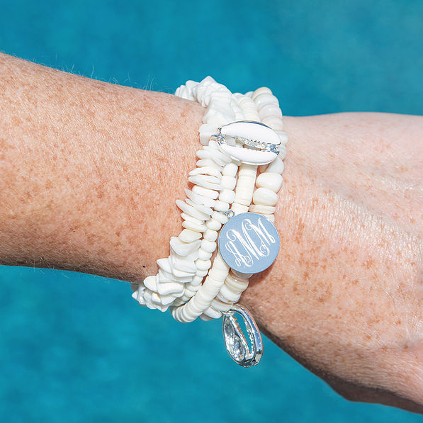 monogrammed aloha bracelet stack on arm above pool