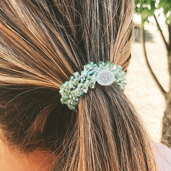 green monogrammed hair tie in hair
