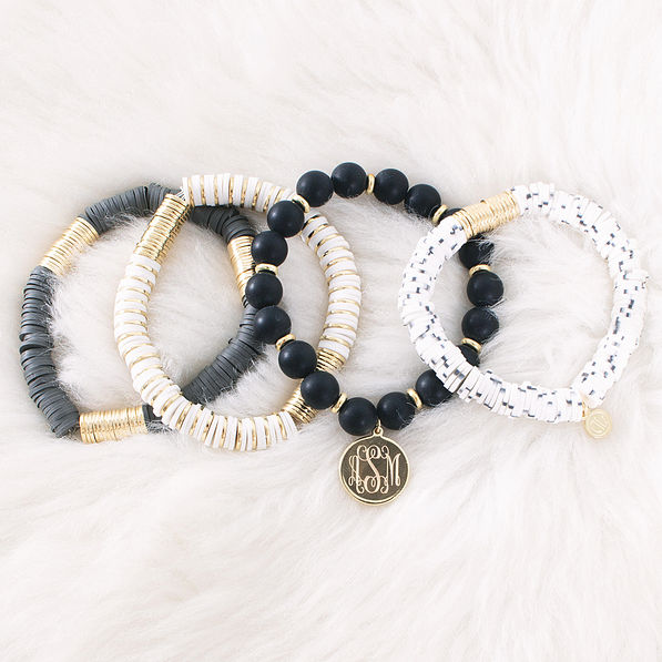 monogrammed spotted bead bracelets on fur rug